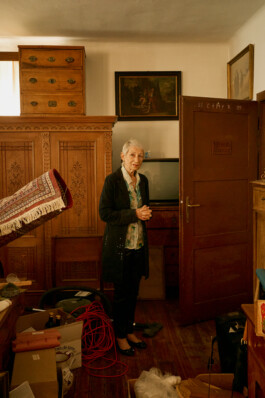 Christina Wirtenberger, a former student of the Goldenstein convent now living in Switzerland, standing in a room helping elderly nuns during their return to the Austrian convent.