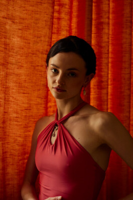 Violetta Keller poses in a red dress for a portrait shot for Myself Germany.